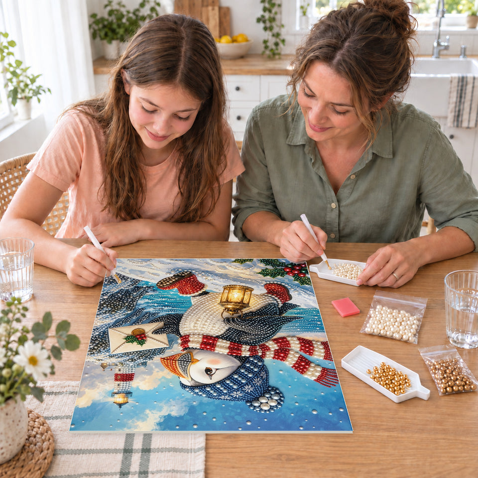 Mother and daughter creating one shared Pearl artwork — Winter Puffin with a Lantern by the Lighthouse. Pearl diamond painting DIY kit by Isuvio.