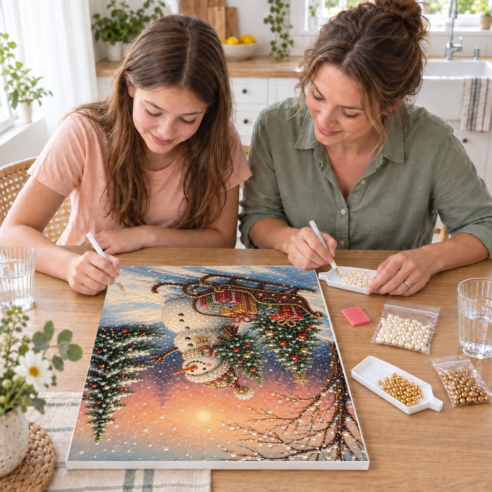Mother and daughter creating one shared Pearl artwork — Snowman and Gift Sleigh at Winter Sunset. Pearl diamond painting DIY kit by Isuvio.