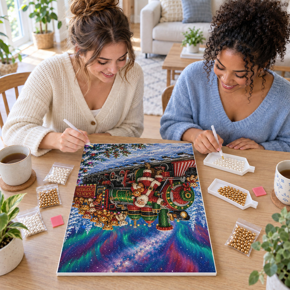 Two friends creating one shared Pearl artwork — Santa Express Beneath the Northern Lights. Pearl diamond painting DIY kit by Isuvio.