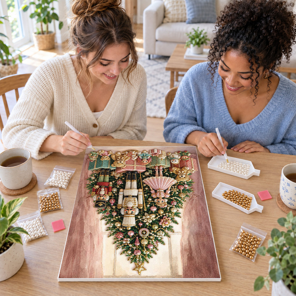 Two friends creating one shared Pearl artwork — Pink Christmas Tree with Nutcrackers and Toys. Pearl diamond painting DIY kit by Isuvio.