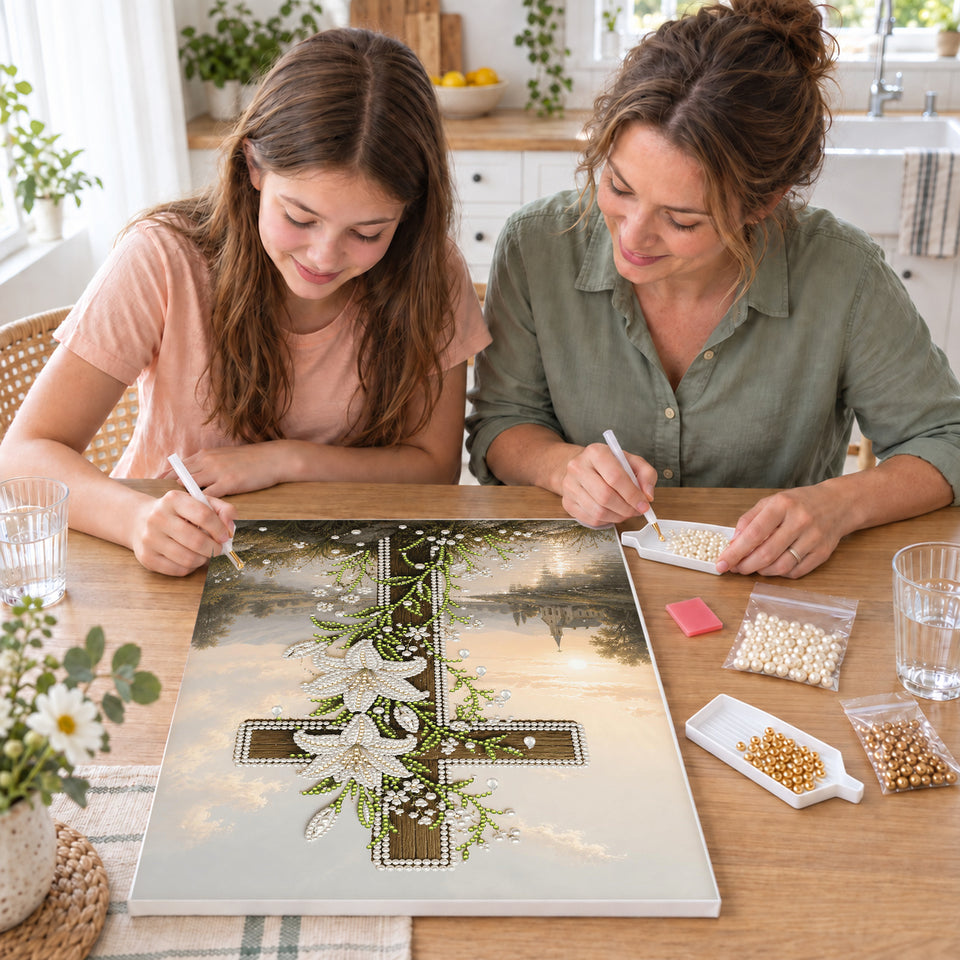 Mother and daughter creating one shared Pearl artwork — Wooden Cross with White Lilies Beside a River. Pearl diamond painting DIY kit by Isuvio.