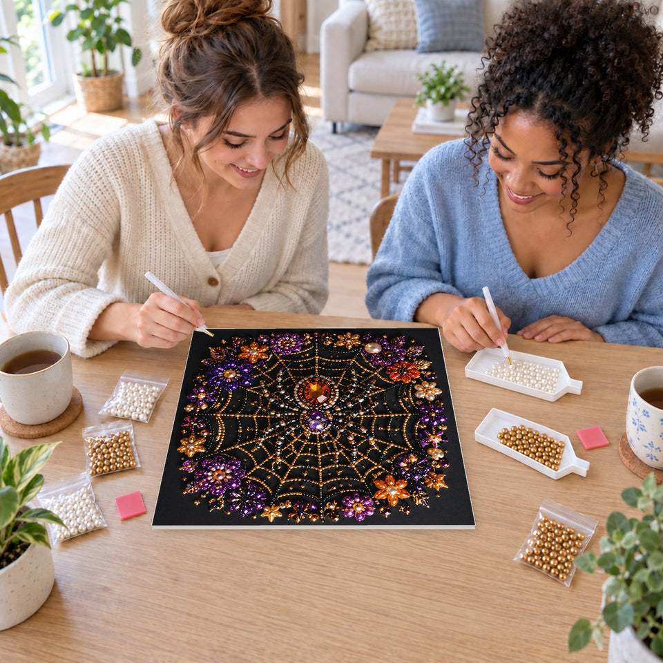 Two friends creating one shared Pearl artwork — Jeweled Spider on a Floral Web. Pearl diamond painting DIY kit by Isuvio.