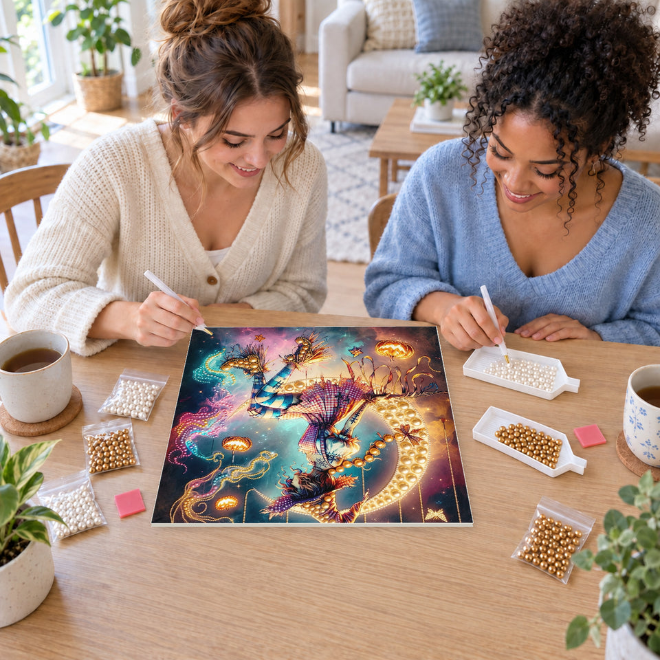 Two friends creating one shared Pearl artwork — Moonlit Witch with Hanging Pumpkins. Pearl diamond painting DIY kit by Isuvio.