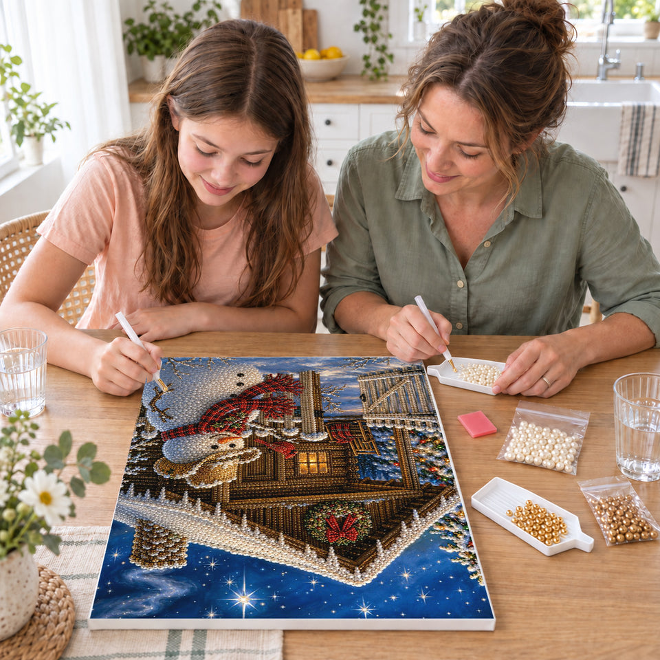 Mother and daughter creating one shared Pearl artwork — Snowman in a Cowboy Hat Beside a Christmas Cabin. Pearl diamond painting DIY kit by Isuvio.