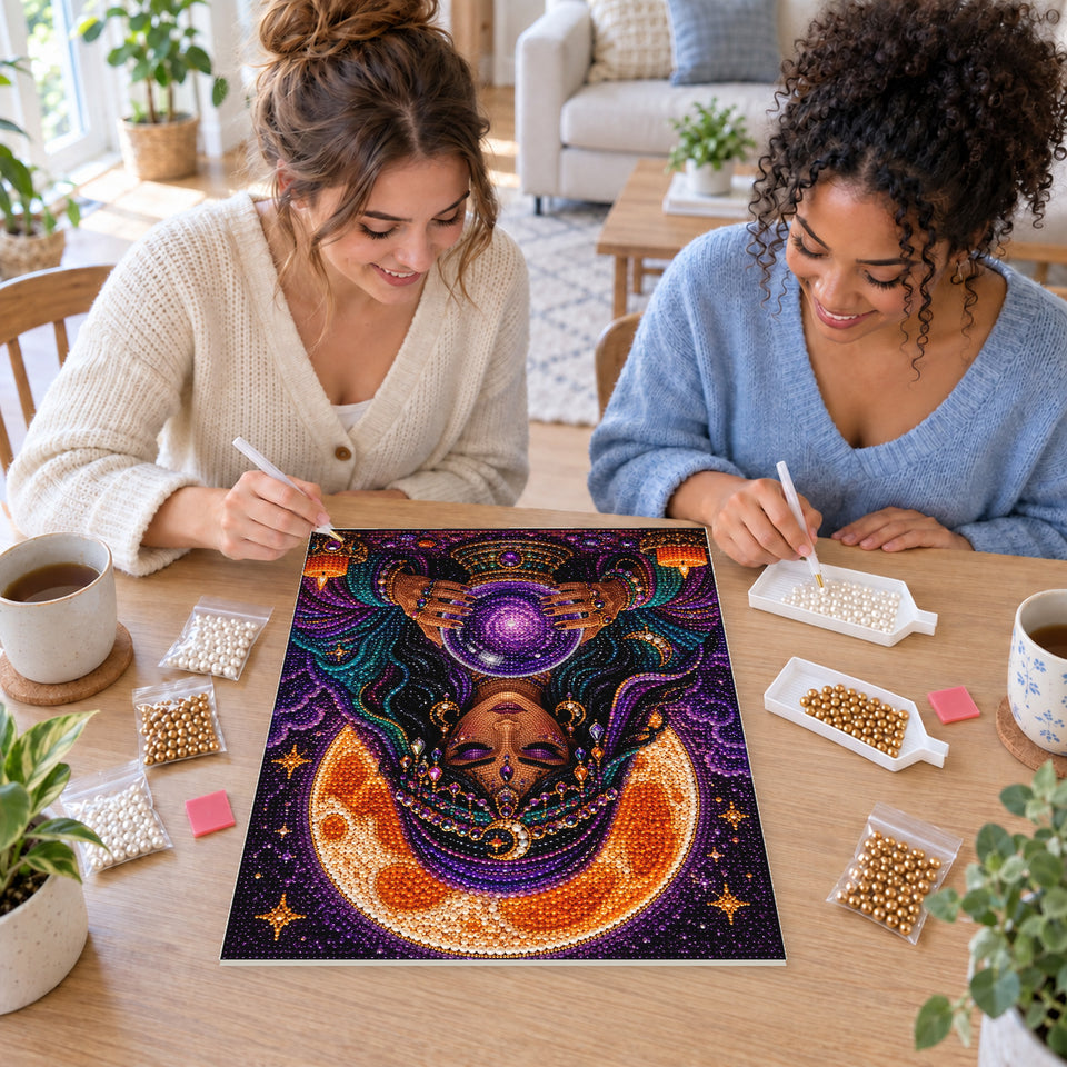 Two friends creating one shared Pearl artwork — Fortune Teller Gazing into a Purple Crystal Ball. Pearl diamond painting DIY kit by Isuvio.
