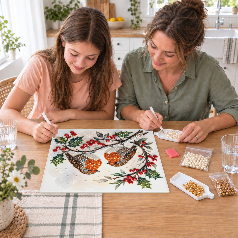 Mother and daughter creating one shared Pearl artwork — Two Robins on Christmas Holly. Pearl diamond painting DIY kit by Isuvio.