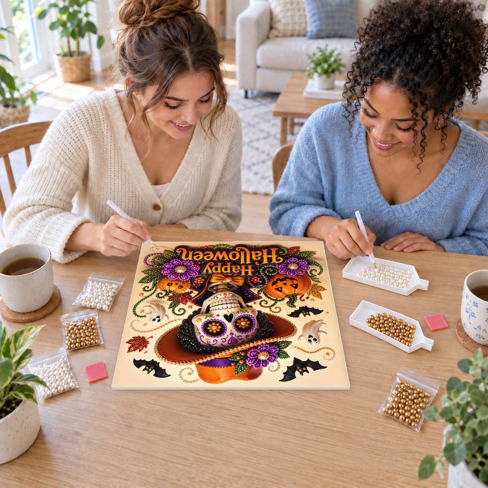 Two friends creating one shared Pearl artwork — Happy Halloween Skeleton in an Orange Hat. Pearl diamond painting DIY kit by Isuvio.