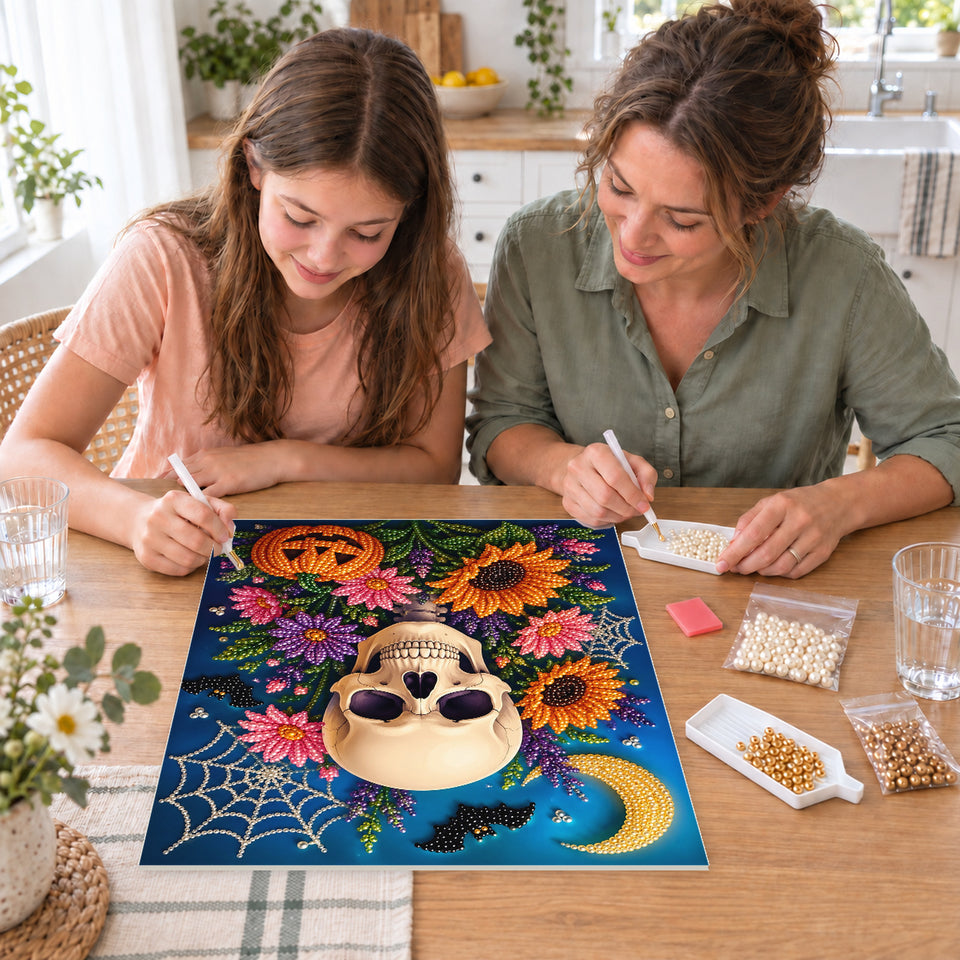 Mother and daughter creating one shared Pearl artwork — Sunflower Skull beneath a Crescent Moon. Pearl diamond painting DIY kit by Isuvio.