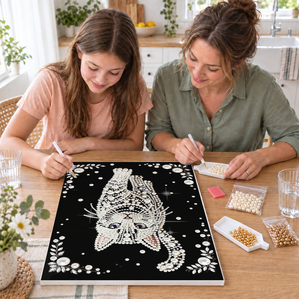 Mother and daughter creating one shared Pearl artwork — White Pearl Cat with Blue Eyes on Black. Pearl diamond painting DIY kit by Isuvio.