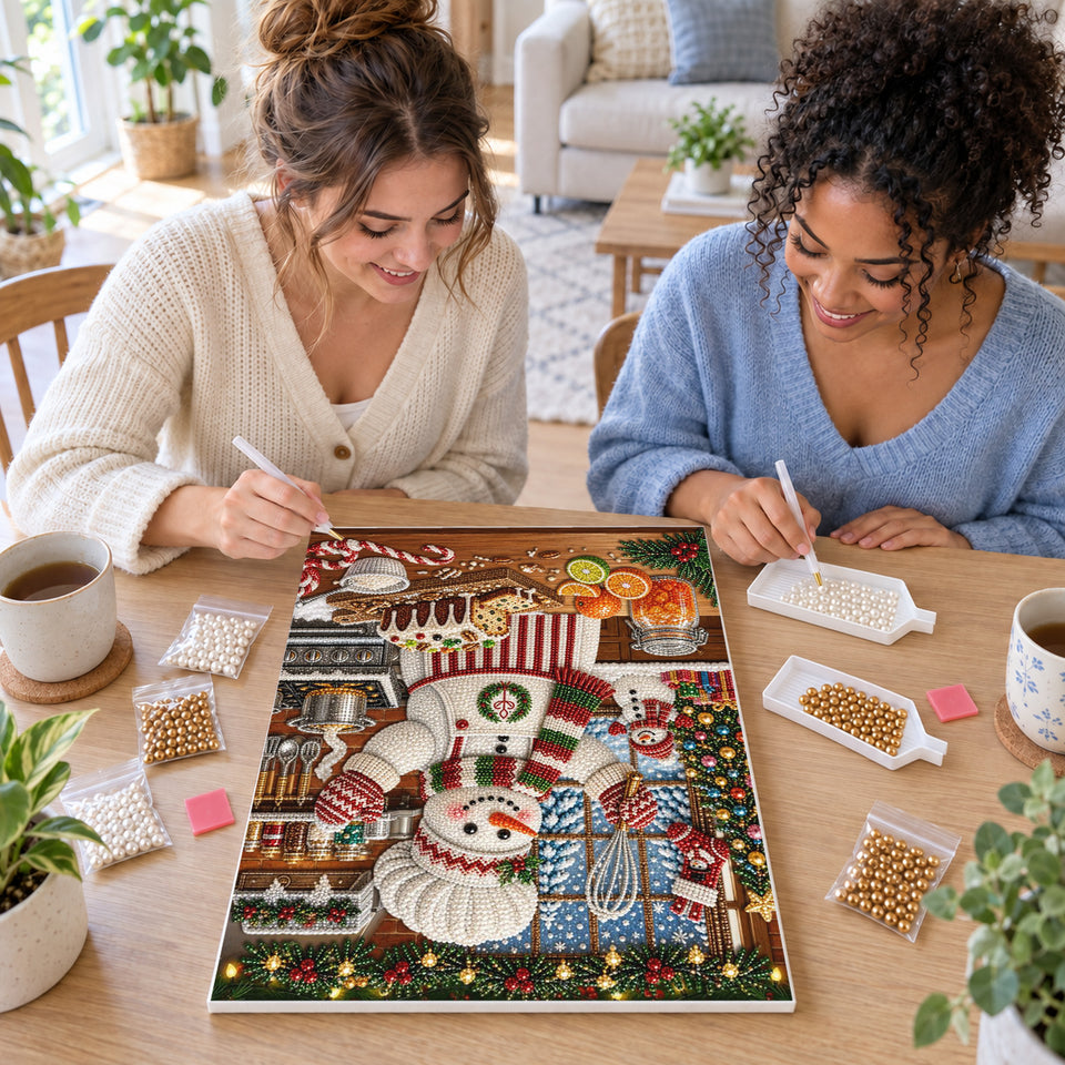Two friends creating one shared Pearl artwork — Snowman Baker in a Christmas Kitchen. Pearl diamond painting DIY kit by Isuvio.