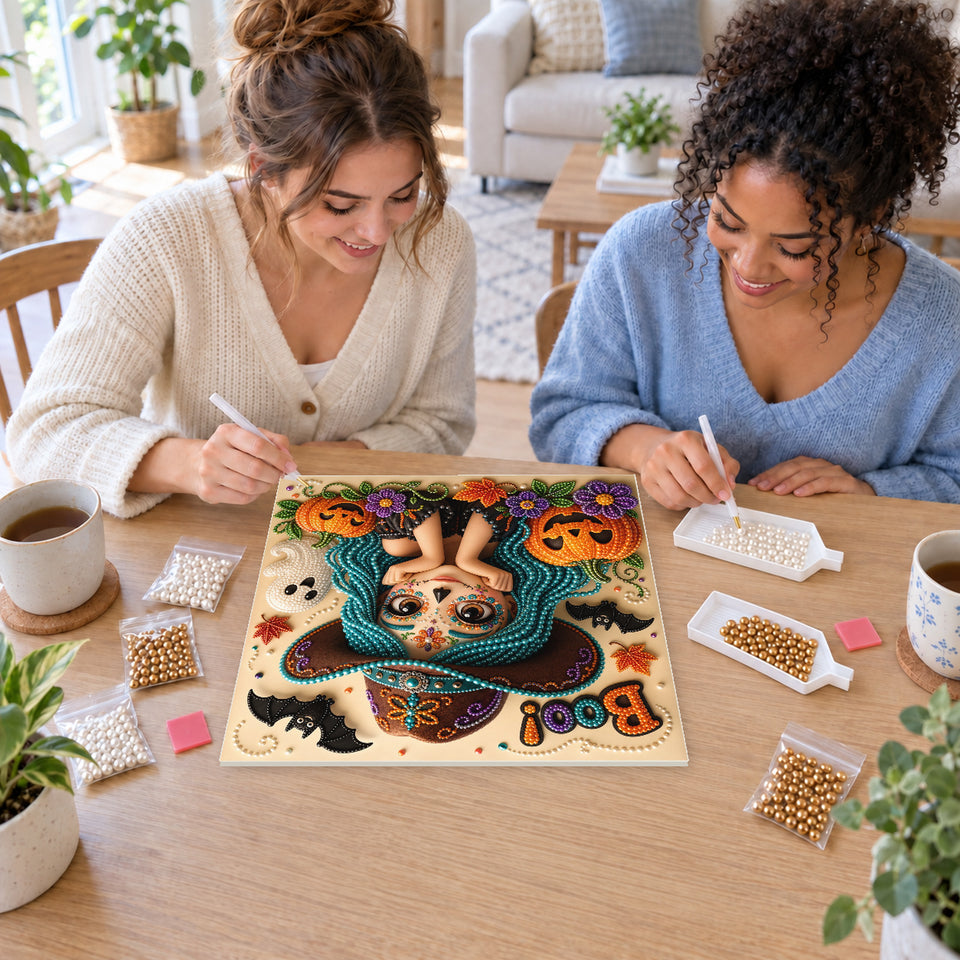 Two friends creating one shared Pearl artwork — Boo Sugar Skull Girl in a Teal Witch Hat. Pearl diamond painting DIY kit by Isuvio.