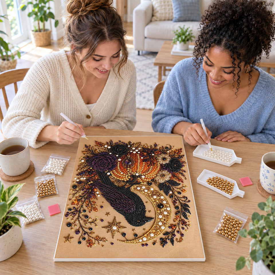 Two friends creating one shared Pearl artwork — Raven Moon and Autumn Pumpkins. Pearl diamond painting DIY kit by Isuvio.