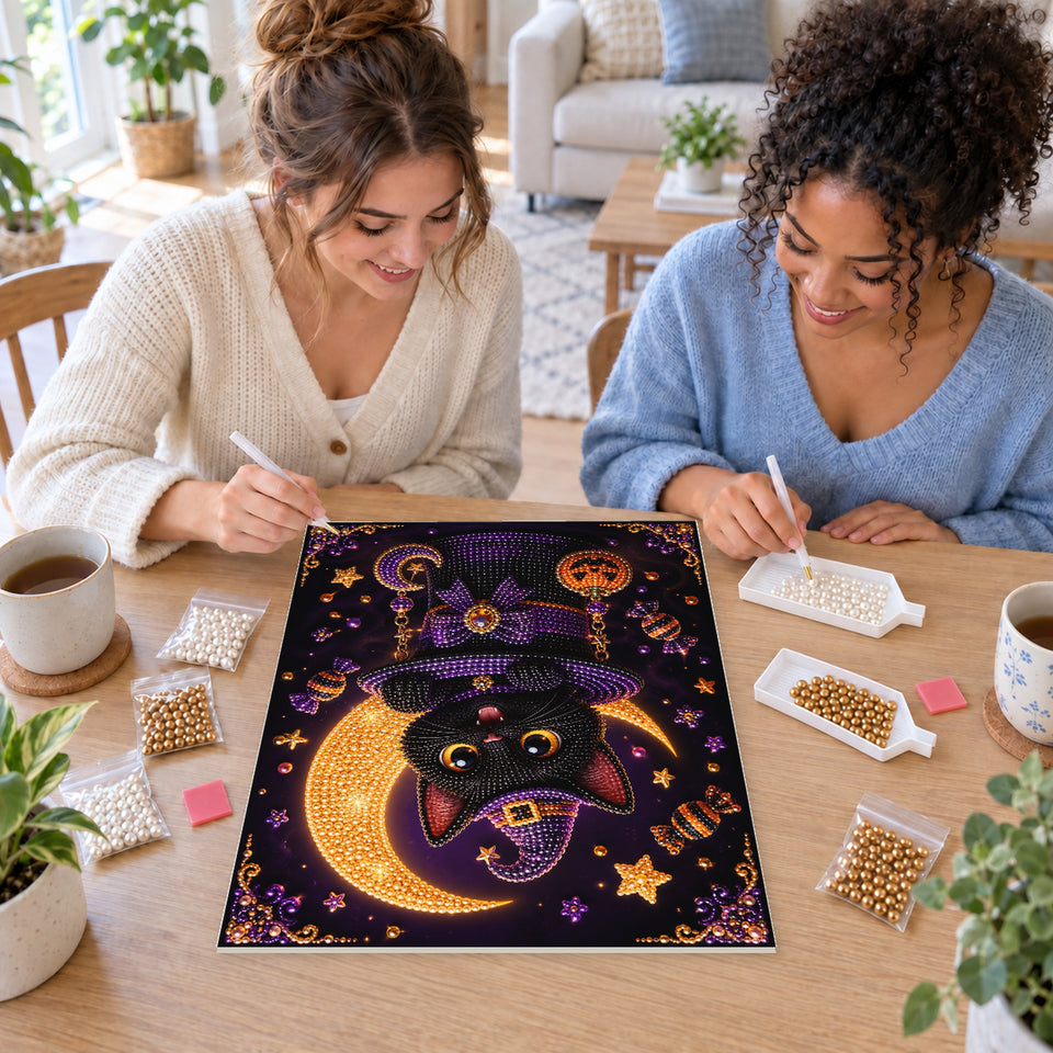 Two friends creating one shared Pearl artwork — Black Cat in a Purple Witch Hat with Pumpkin Charms. Pearl diamond painting DIY kit by Isuvio.