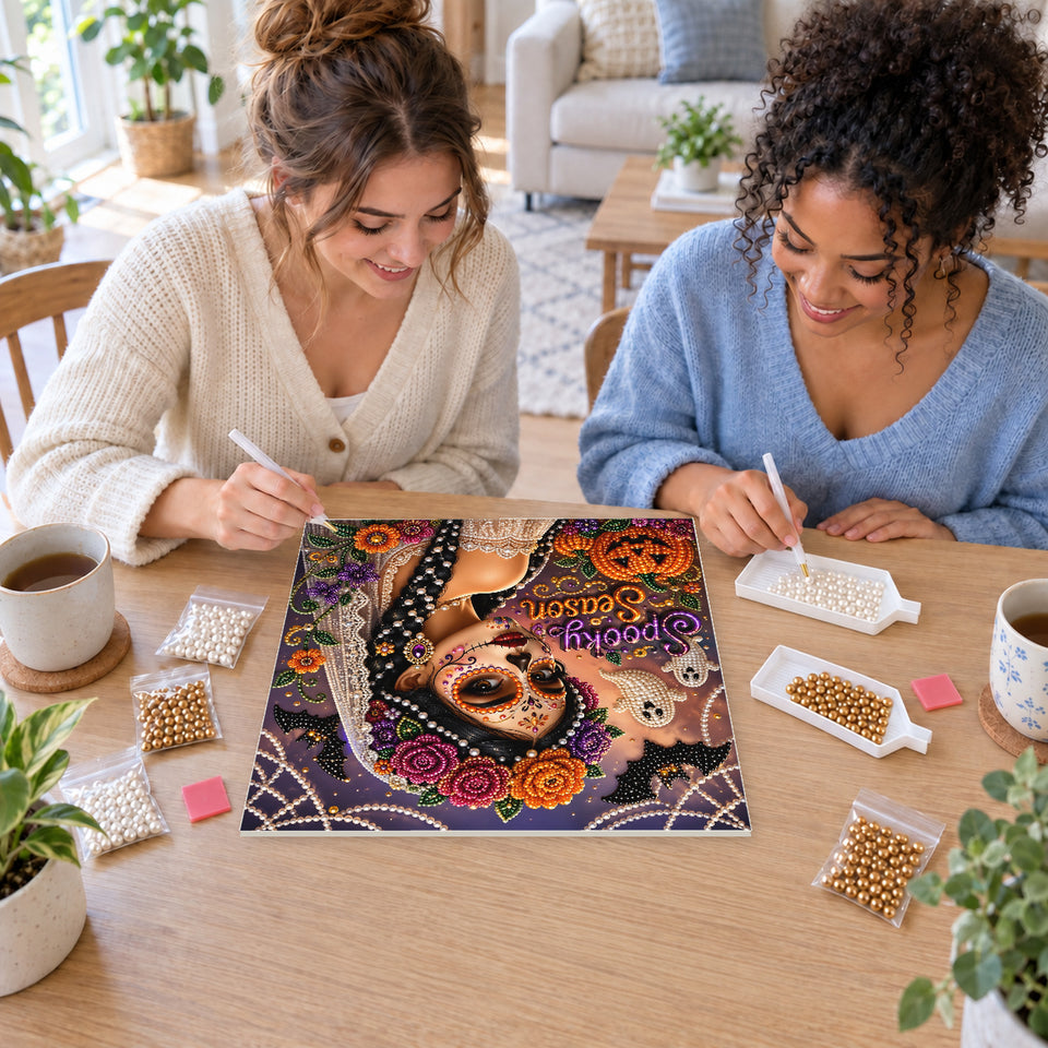 Two friends creating one shared Pearl artwork — Spooky Season Floral Sugar Skull Portrait. Pearl diamond painting DIY kit by Isuvio.