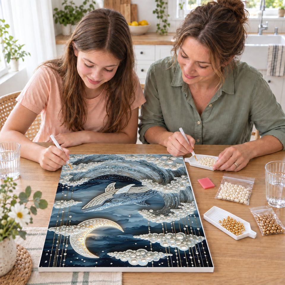 Mother and daughter creating one shared Pearl artwork — Whale Rising Through Moonlit Pearl Waves. Pearl diamond painting DIY kit by Isuvio.