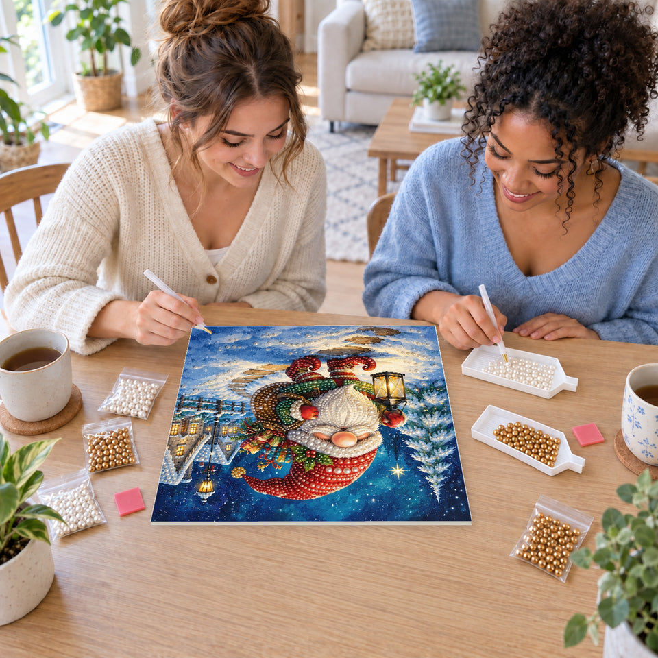 Two friends creating one shared Pearl artwork — Christmas Gnome on a Snowy Village Walk. Pearl diamond painting DIY kit by Isuvio.