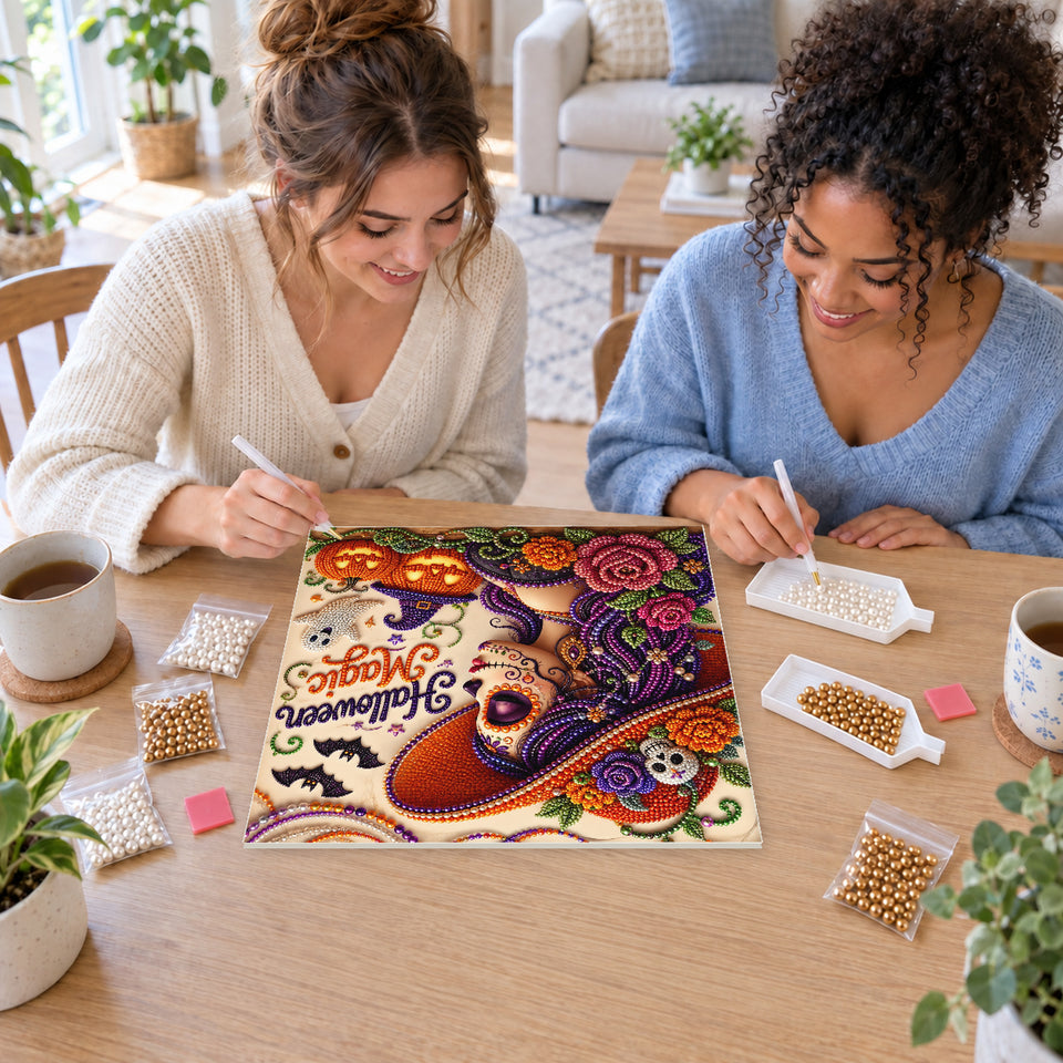 Two friends creating one shared Pearl artwork — Halloween Magic with a Purple-Haired Witch. Pearl diamond painting DIY kit by Isuvio.