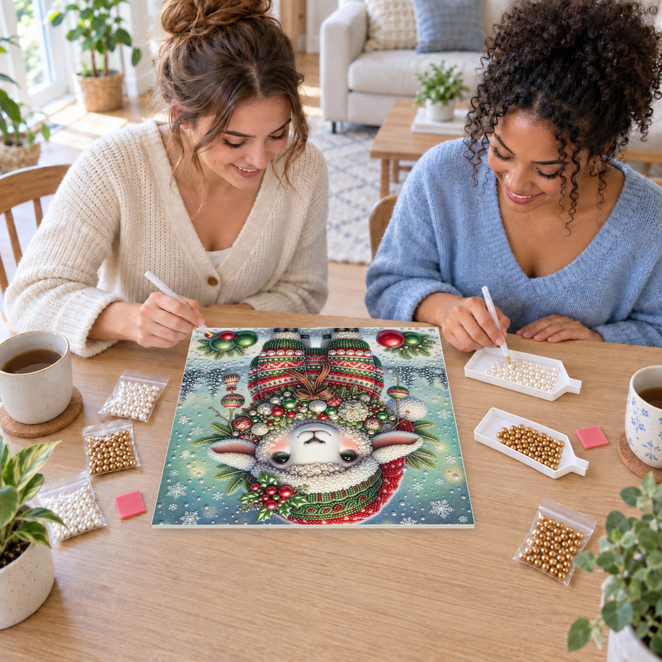 Two friends creating one shared Pearl artwork — Little Lamb in a Christmas Hat and Festive Sweater. Pearl diamond painting DIY kit by Isuvio.