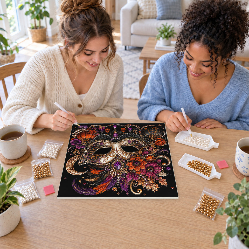 Two friends creating one shared Pearl artwork — Masquerade Mask with Autumn Flowers and Feathers. Pearl diamond painting DIY kit by Isuvio.
