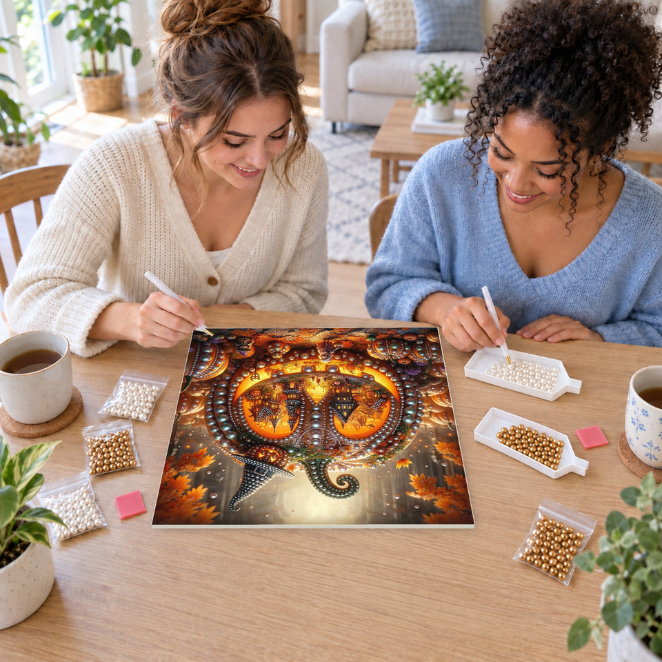 Two friends creating one shared Pearl artwork — Tiny Haunted Village inside a Pumpkin. Pearl diamond painting DIY kit by Isuvio.