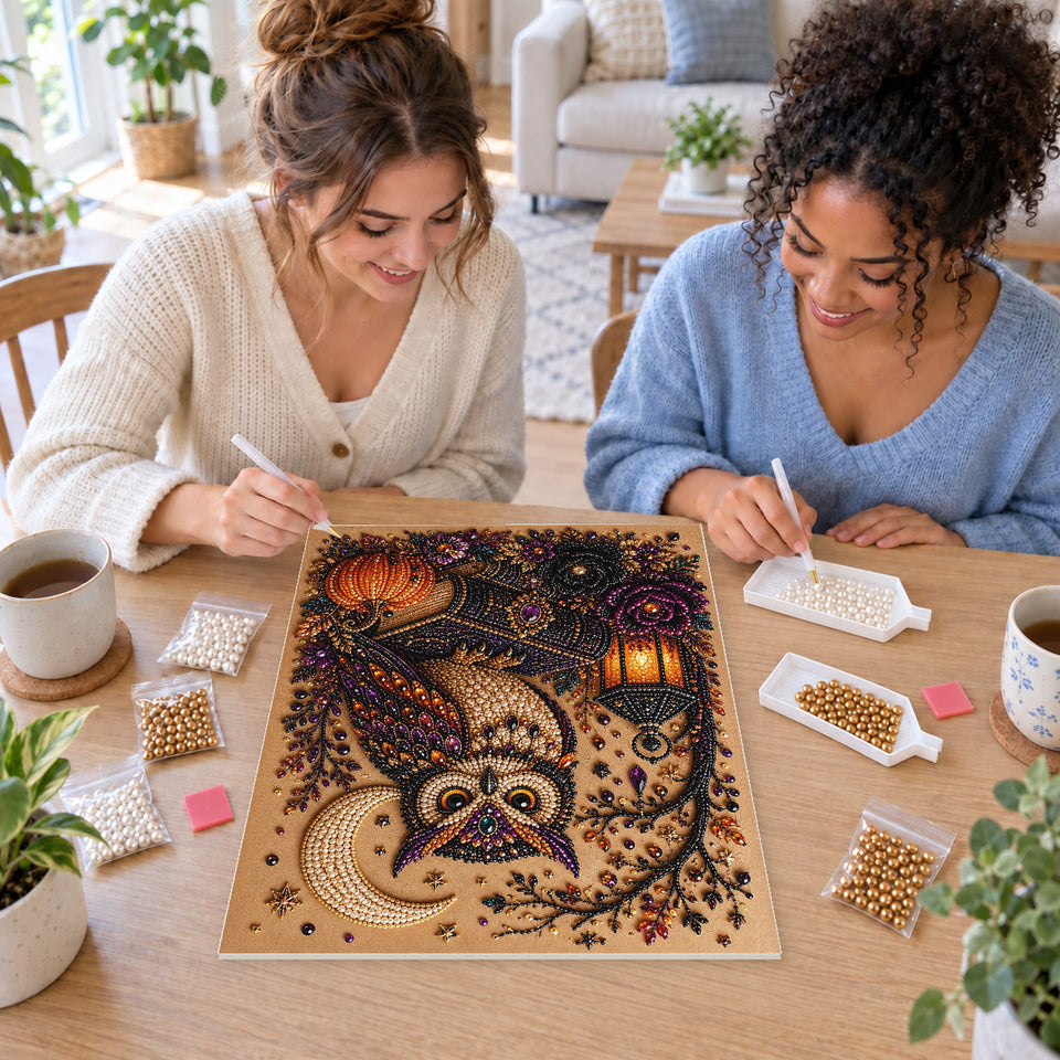 Two friends creating one shared Pearl artwork — Jeweled Owl on Spell Books Beside a Lantern. Pearl diamond painting DIY kit by Isuvio.
