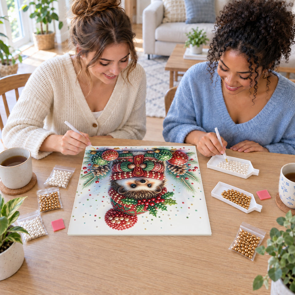 Two friends creating one shared Pearl artwork — Christmas Hedgehog among Colorful Baubles. Pearl diamond painting DIY kit by Isuvio.