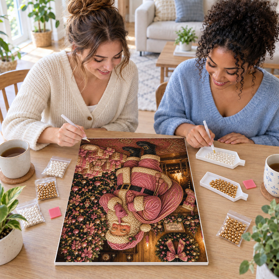 Two friends creating one shared Pearl artwork — Pink Santa Beside a Rose-Colored Christmas Tree. Pearl diamond painting DIY kit by Isuvio.