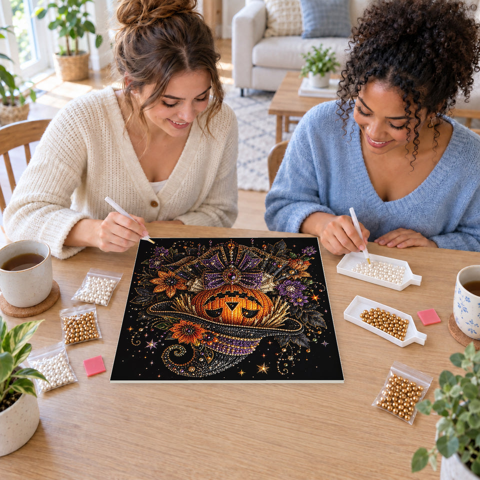 Two friends creating one shared Pearl artwork — Pumpkin Witch in an Ornate Hat and Floral Collar. Pearl diamond painting DIY kit by Isuvio.