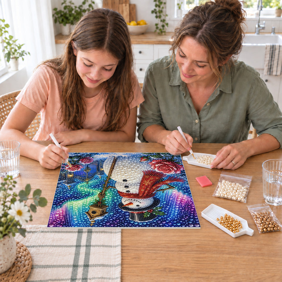 Mother and daughter creating one shared Pearl artwork — Snowman with a Birdhouse beneath the Aurora. Pearl diamond painting DIY kit by Isuvio.