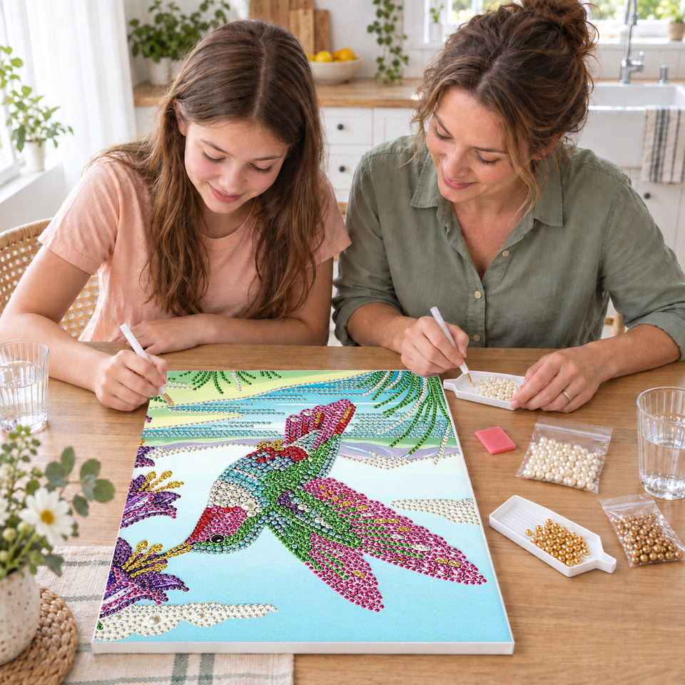 Mother and daughter creating one shared Pearl artwork — Rainbow Hummingbird Beside Purple Flowers. Pearl diamond painting DIY kit by Isuvio.