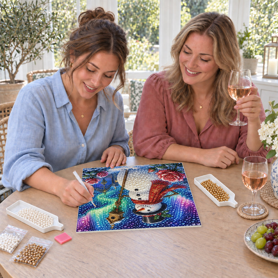 Friends enjoying a sip and craft session — Snowman with a Birdhouse beneath the Aurora. Pearl diamond painting DIY kit by Isuvio.