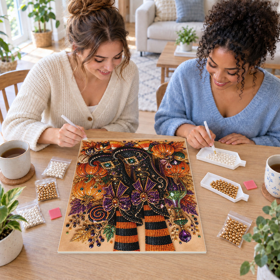 Two friends creating one shared Pearl artwork — Curled Witch Boots with Pumpkins and Purple Bows. Pearl diamond painting DIY kit by Isuvio.