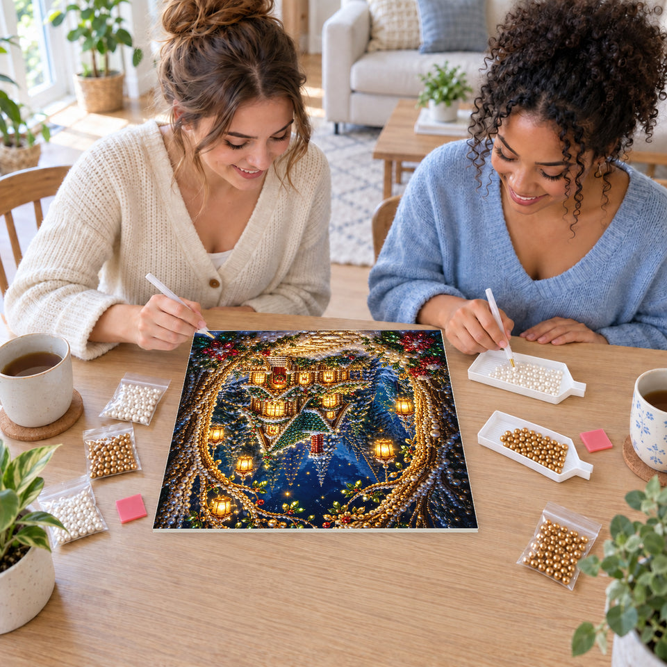 Two friends creating one shared Pearl artwork — Christmas Cottage Beneath a Glowing Woodland Arch. Pearl diamond painting DIY kit by Isuvio.