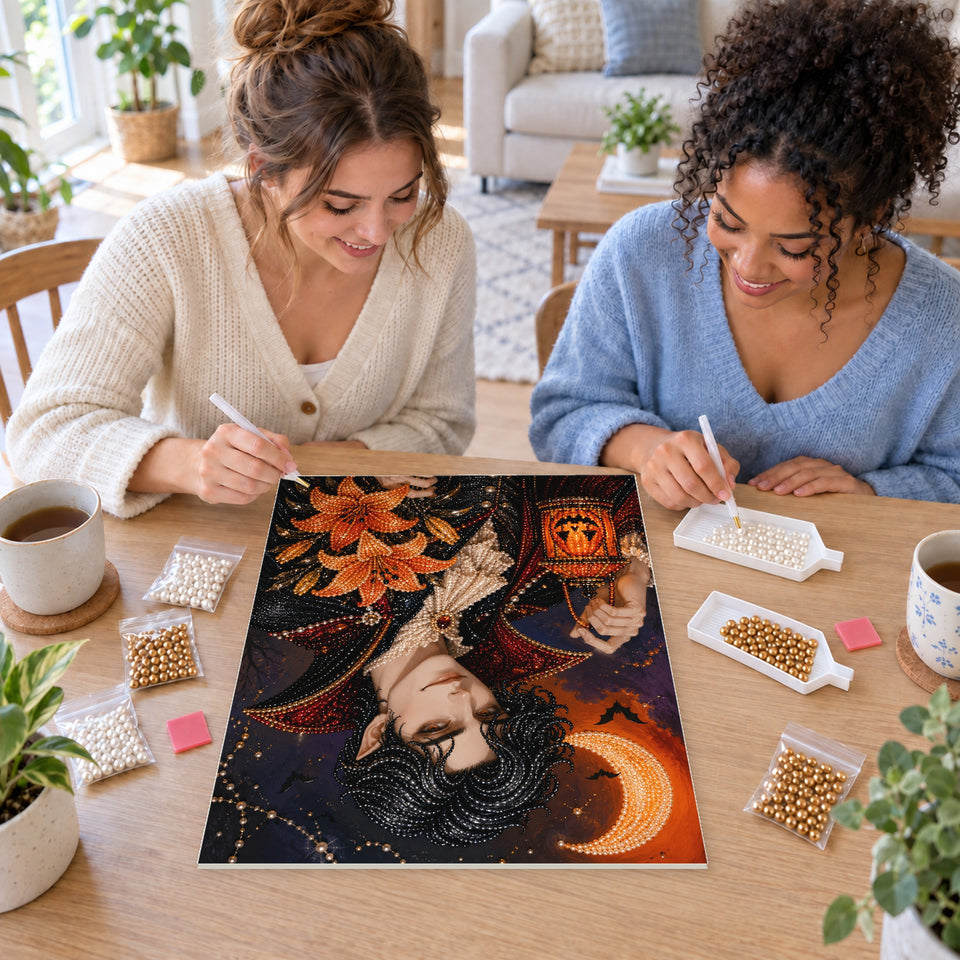 Two friends creating one shared Pearl artwork — Moonlit Vampire with Orange Lilies. Pearl diamond painting DIY kit by Isuvio.