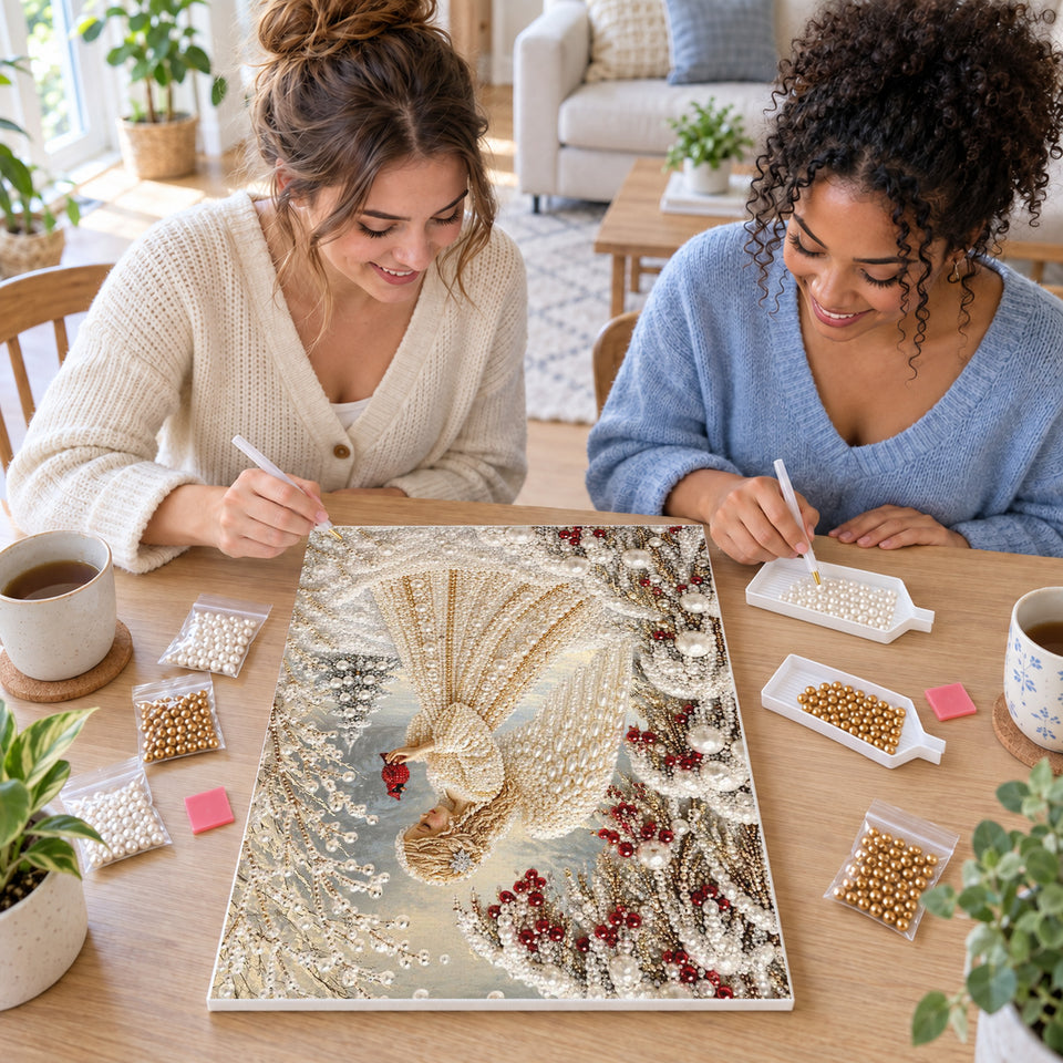 Two friends creating one shared Pearl artwork — Angel in Snow with Cardinal. Pearl diamond painting DIY kit by Isuvio.