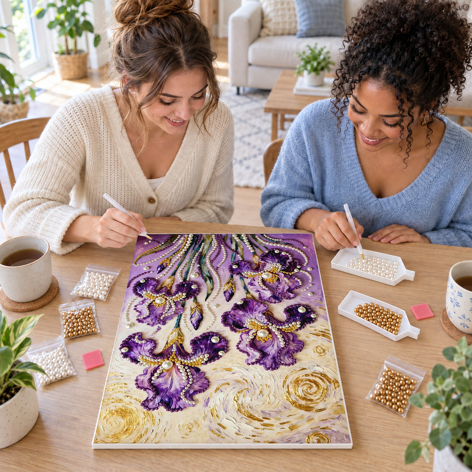 Two friends creating one shared Pearl artwork — Purple Irises Beneath a Swirling Golden Sky. Pearl diamond painting DIY kit by Isuvio.