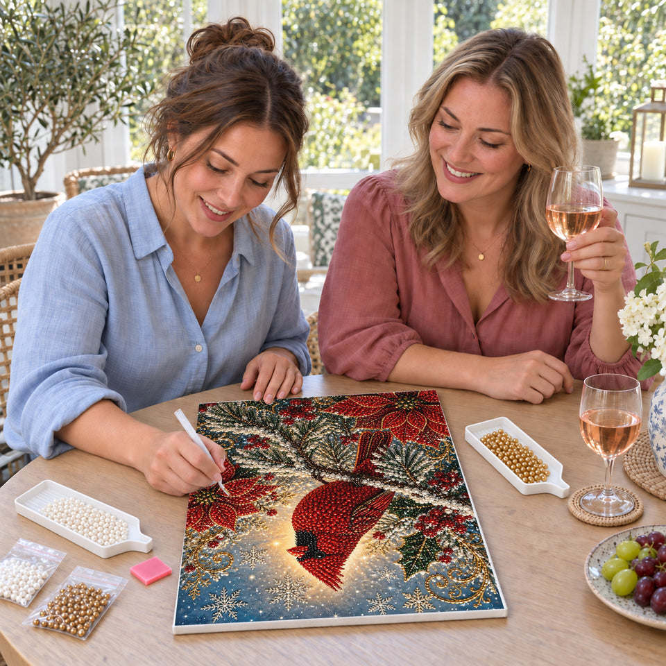 Friends enjoying a sip and craft session — Red Cardinal Among Poinsettias and Snowy Branches. Pearl diamond painting DIY kit by Isuvio.