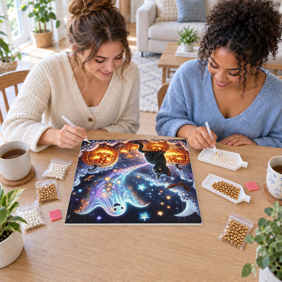 Two friends creating one shared Pearl artwork — Rainbow Ghost with a Black Cat and Jack-o'-Lanterns. Pearl diamond painting DIY kit by Isuvio.