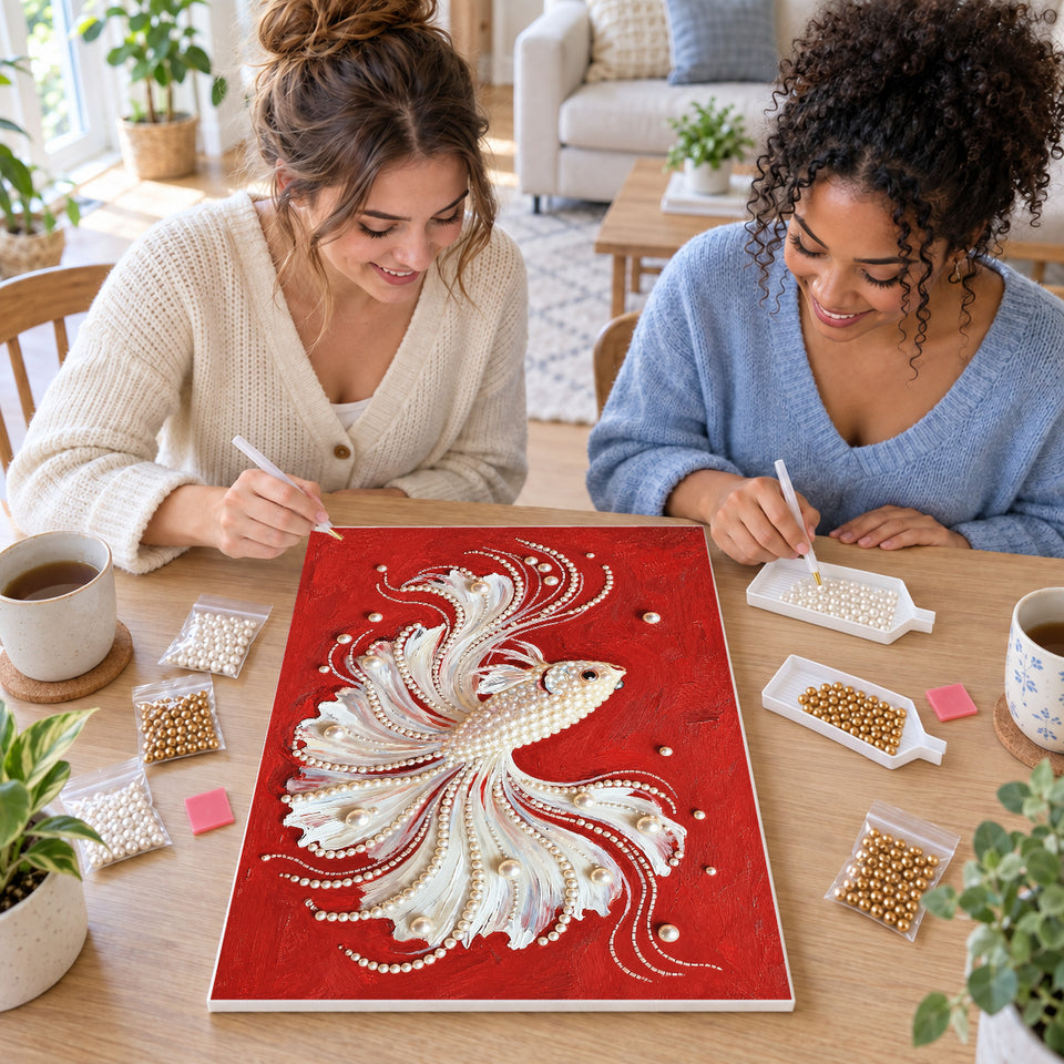 Two friends creating one shared Pearl artwork — White Pearl Betta on Red. Pearl diamond painting DIY kit by Isuvio.